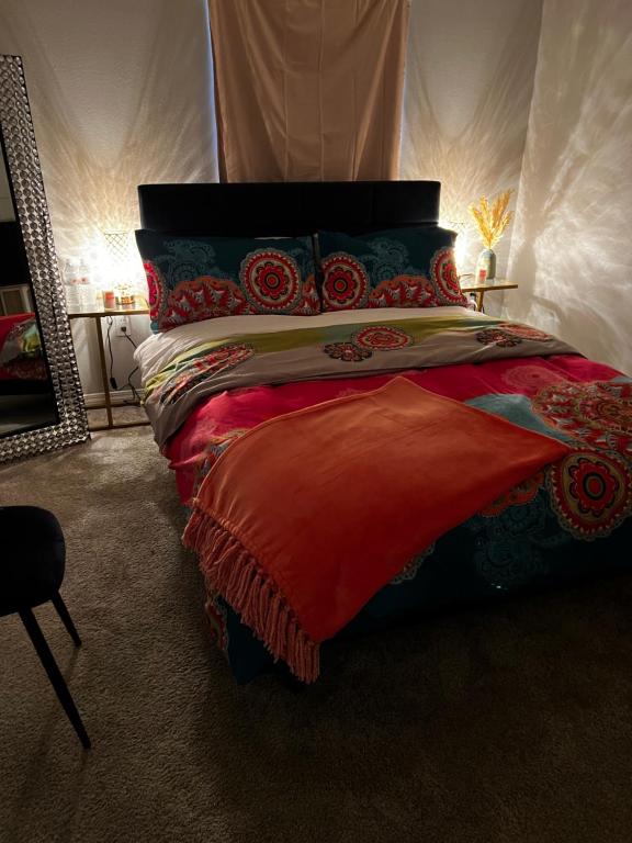 a bedroom with a large bed with a red blanket at Wanda’s pad in Los Angeles