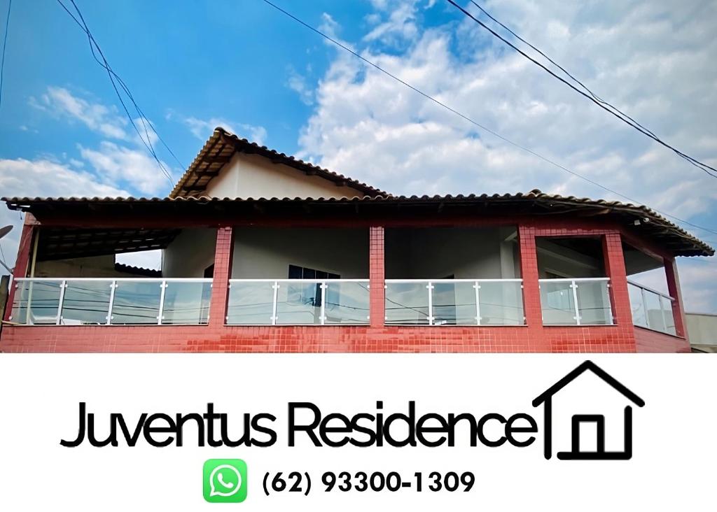 a house with a balcony in front of it at Juventus Residence in Goiânia