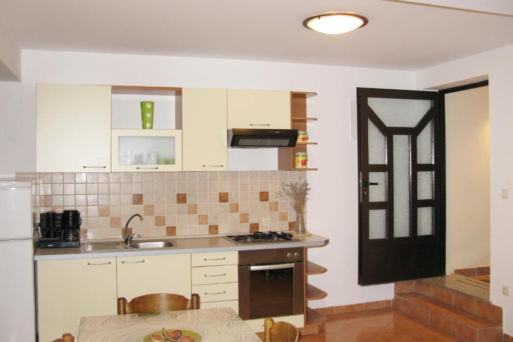 a kitchen with a sink and a stove top oven at Apartments by the sea Cres - 8095 in Cres