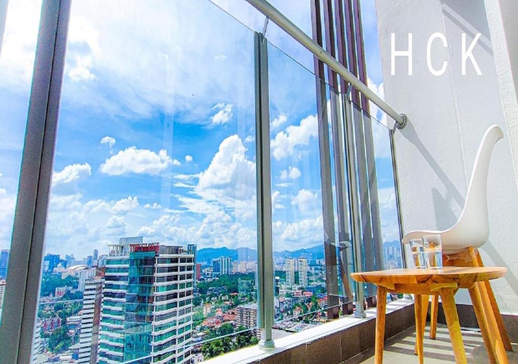 a room with a window with a view of a city at Titiwangsa Core at TR Residence by HCK in Kuala Lumpur