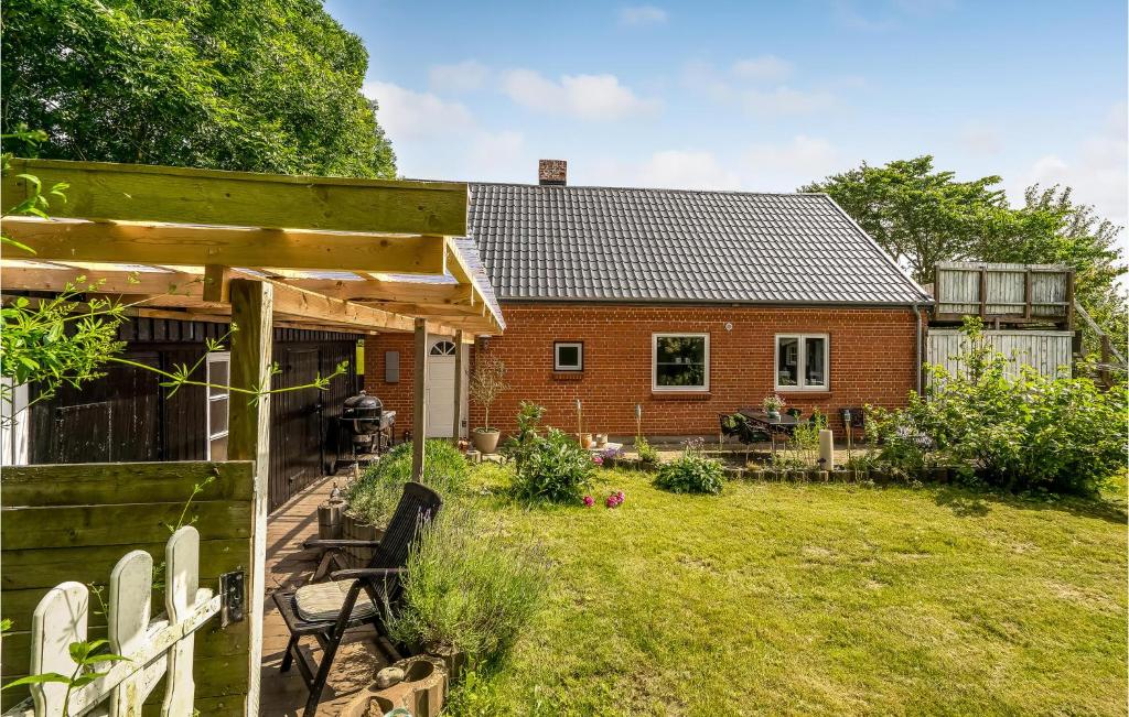 a brick house with a yard and a house at Cozy Home In Vestervig With Kitchen in Vestervig
