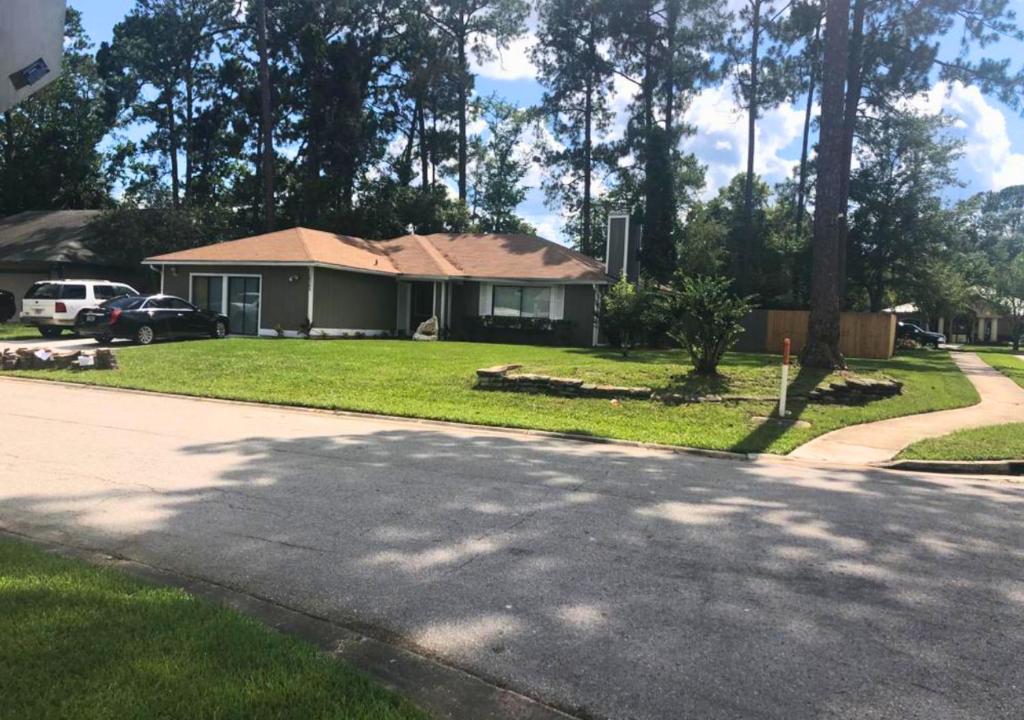 a house on a street with a driveway at Comfy Beautiful 3 bedroom Home in Jacksonville in Jacksonville