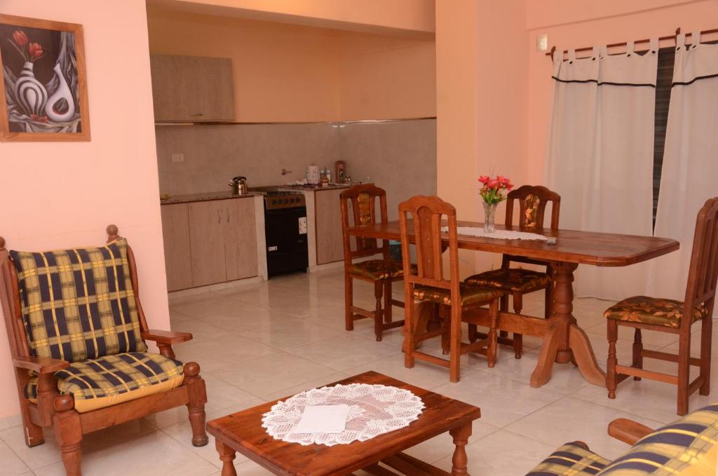 a living room with a table and chairs and a kitchen at Apartamentos El Mirador 3 C in El Carmen