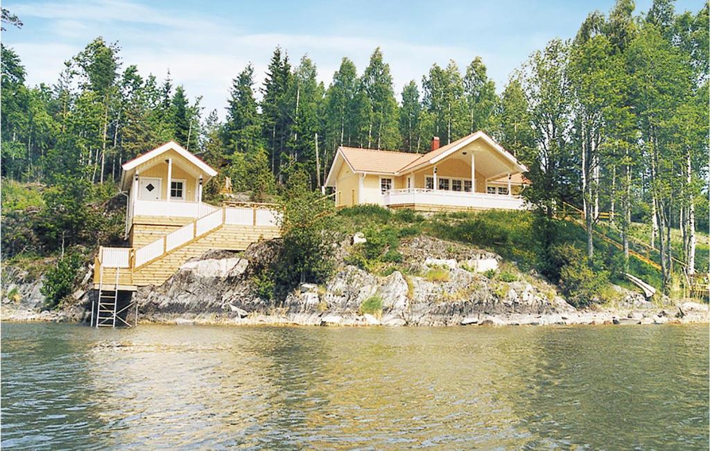 a house on the shore of a body of water at Amazing Home In Segmon With Sauna in Kangerud
