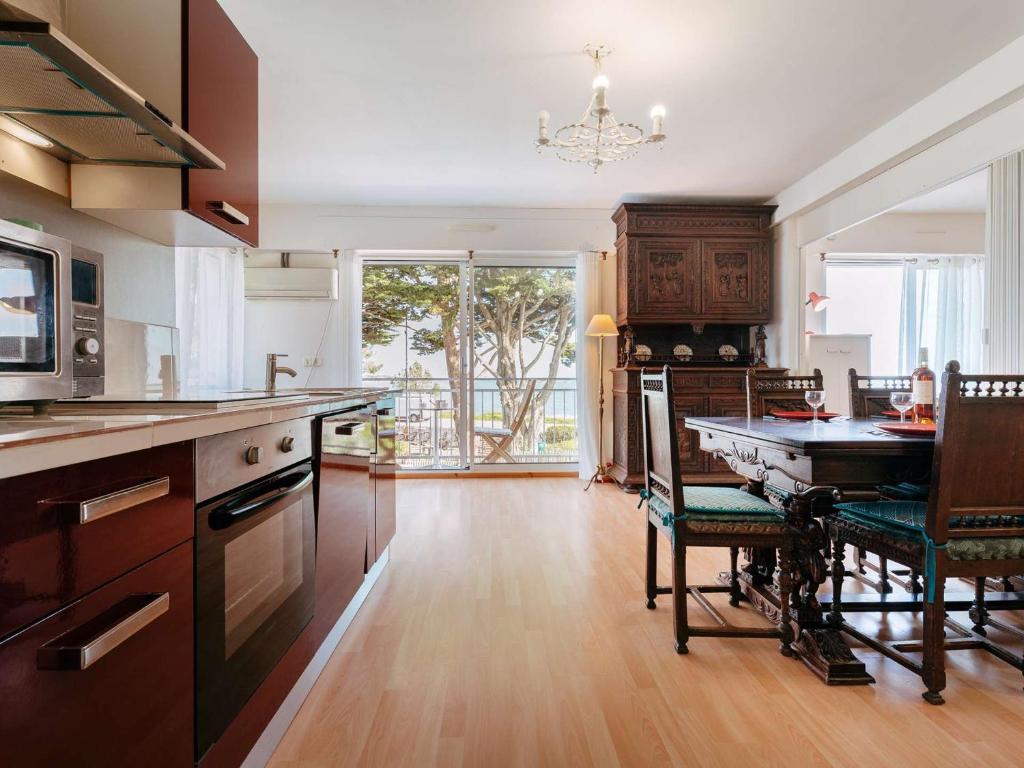 a kitchen with a table and a dining room at Appart 3P pour 4, plage à 20m, wifi, balcon - FR-1-477-225 in La Trinité-sur-Mer