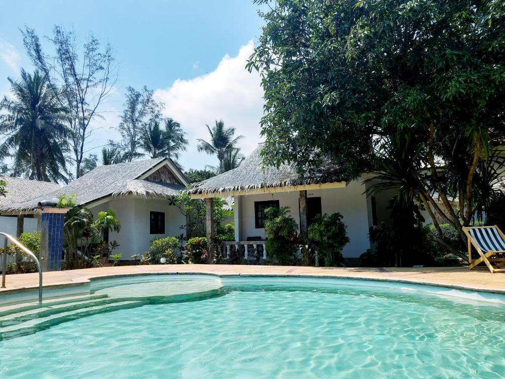 a swimming pool in front of a house at Phuwadee Resort in Thong Nai Pan Noi