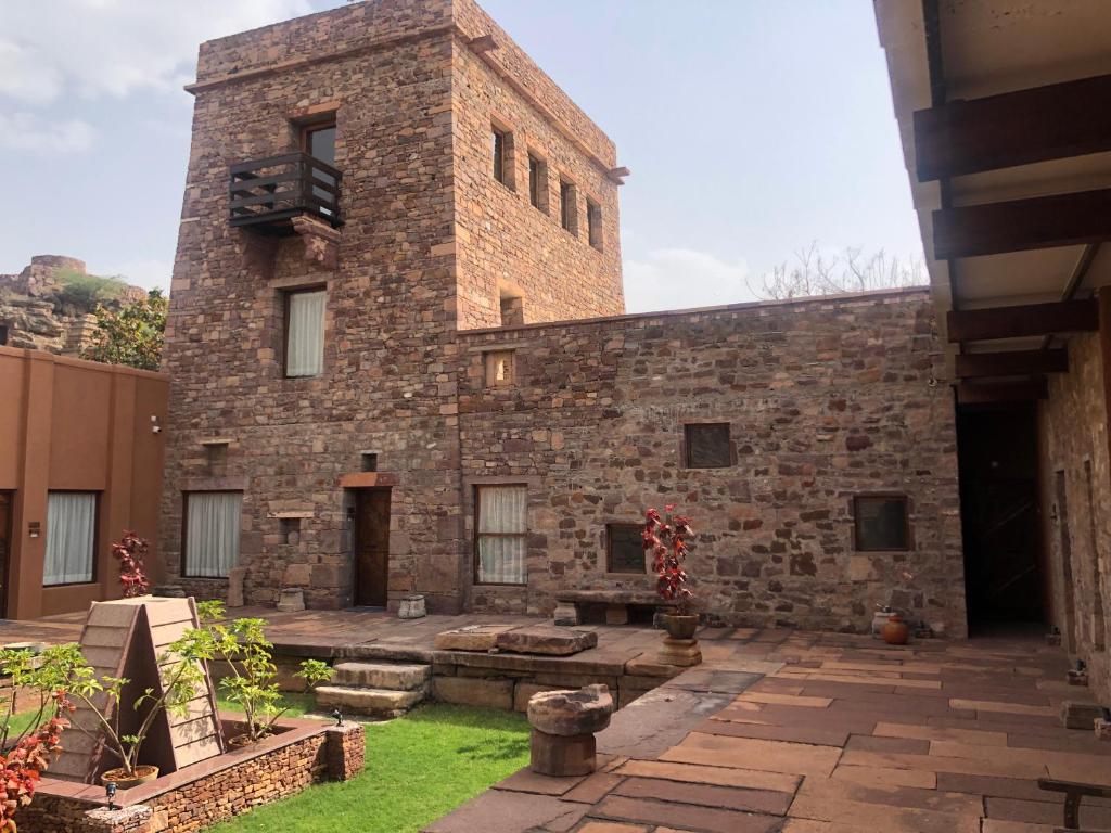 a large brick building with a balcony on top at Wada1 in Aihole