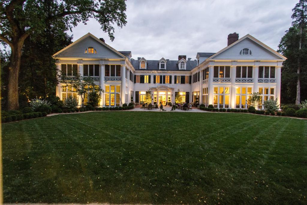 a large white house with a large lawn at The Duke Mansion in Charlotte
