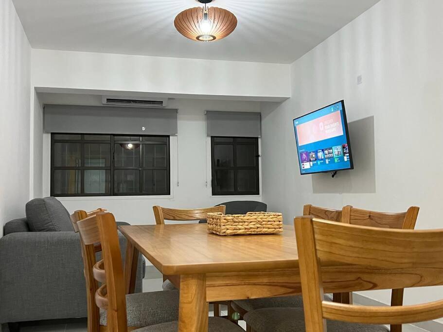 a dining room with a table and chairs and a flat screen tv at NUEVO y moderno en Alta Córdoba in Córdoba
