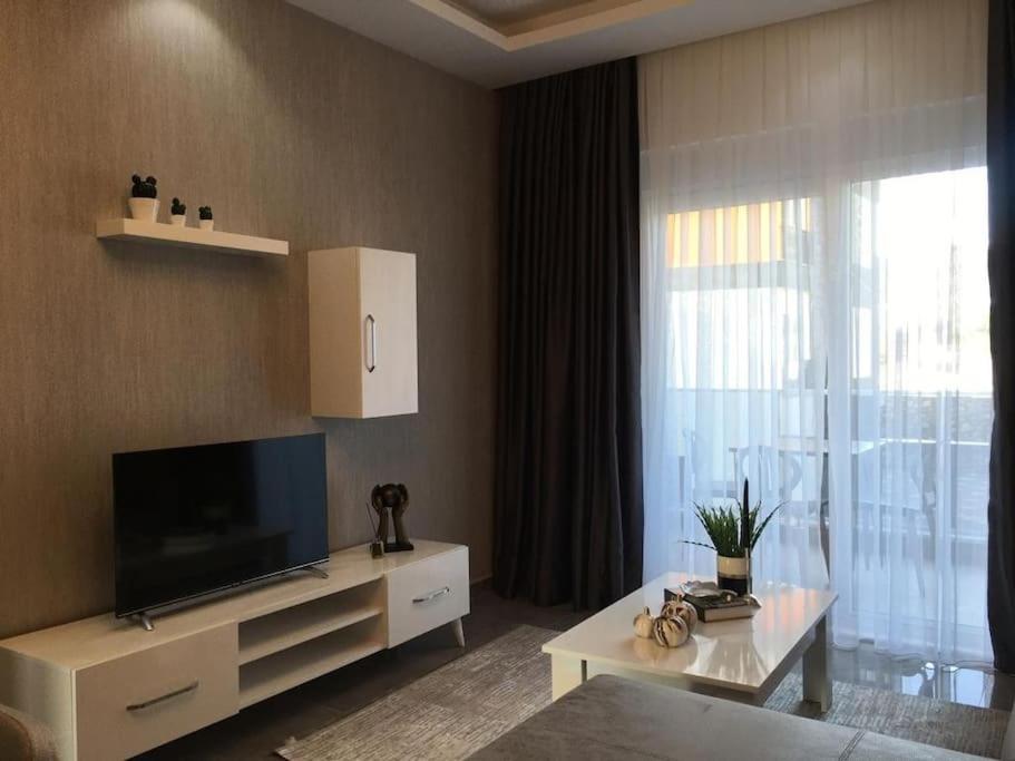 a living room with a tv and a large window at 2 Zimmer Apartment in Avsallar in Alanya