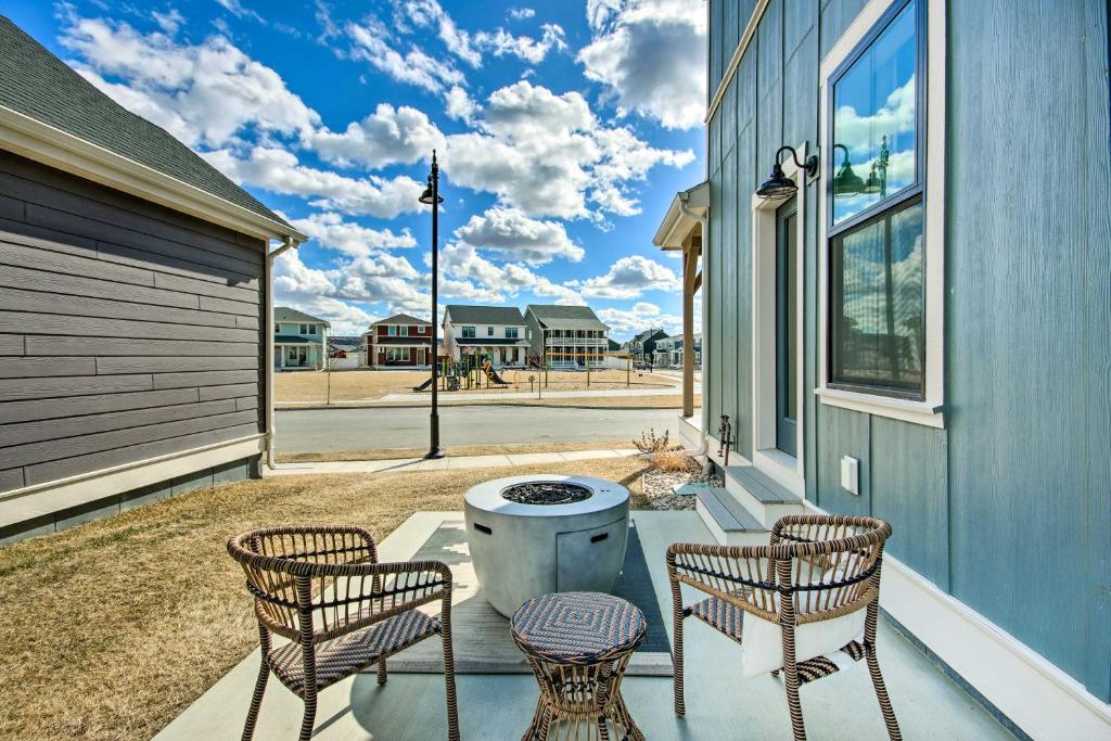 a patio with three chairs and a grill on a house at Cozy Montana Retreat with Patio and Fire Pit! in Billings