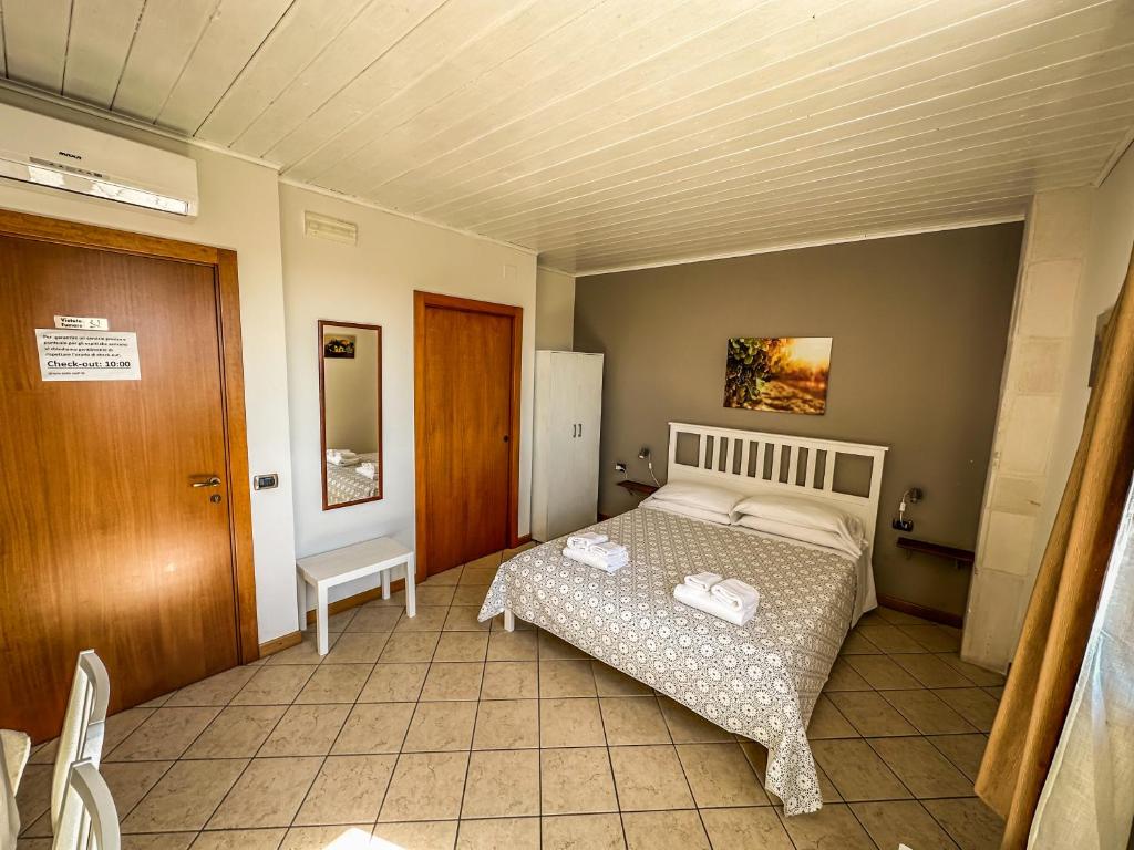 Letto o letti in una camera di B&B Il Leccio