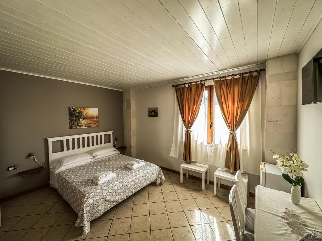 Letto o letti in una camera di B&B Il Leccio