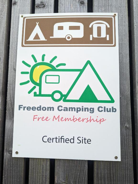 a sign on a fence that reads freedom camping club free membership at Luxury Glamping Cabin with Outdoor Bath on Cornish Flower Farm in Truro
