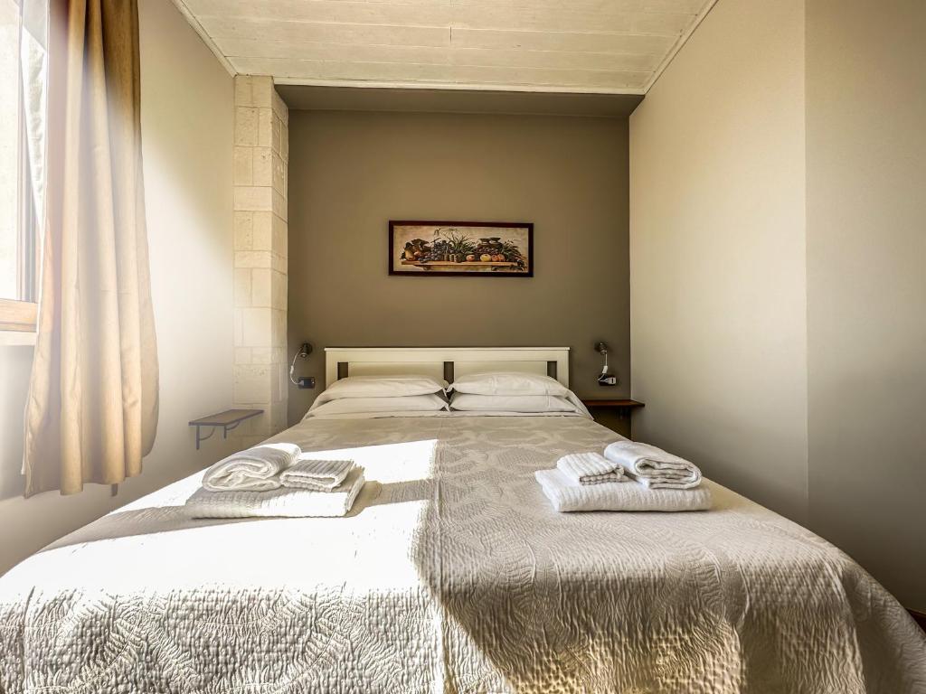 Letto o letti in una camera di B&B Il Leccio