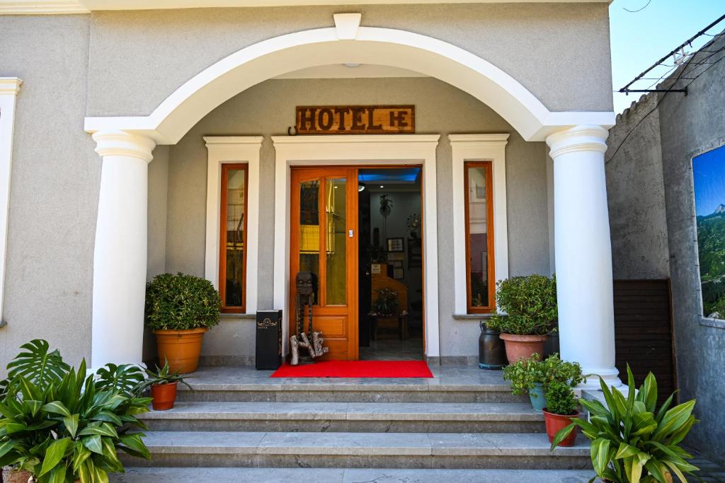 a hotel entrance with a red rug in front of the door at Hotel Epoka in Shkodër