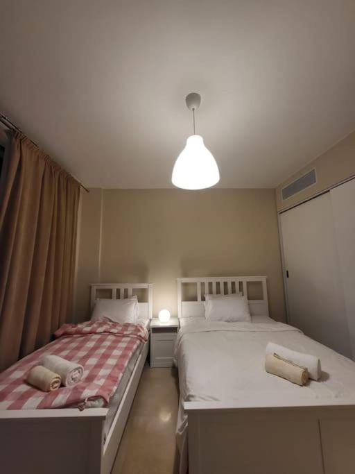 A bed or beds in a room at Mangroovy - 2BR La Blanca Pool View