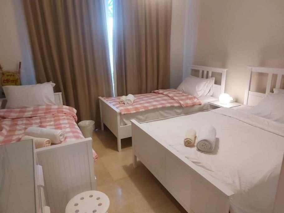 A bed or beds in a room at Mangroovy - 2BR La Blanca Pool View