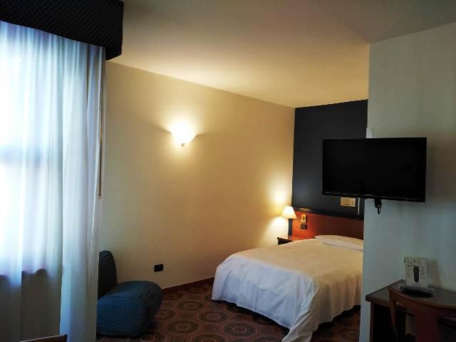 Postel nebo postele na pokoji v ubytování DOMUS Grand Hotel