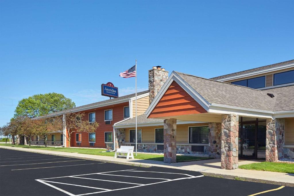 an empty parking lot in front of a hotel at AmericInn by Wyndham Elkhorn Near Lake Geneva in Elkhorn