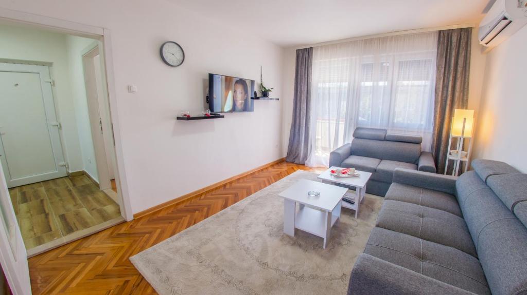 a living room with a couch and a table at Elegant Avenue Escape in Mostar