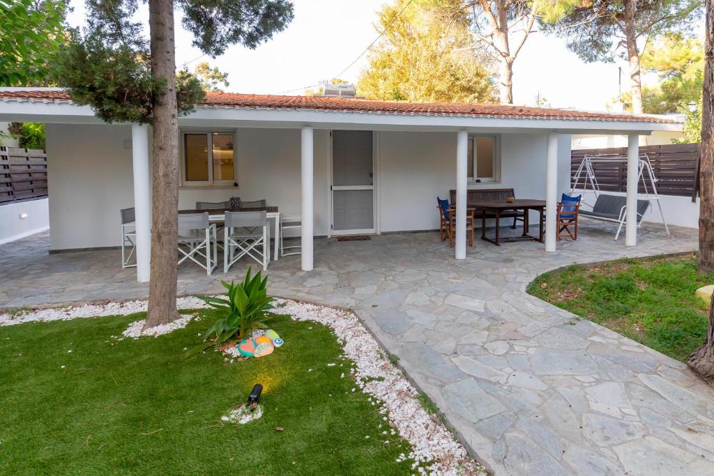 a house with a patio with a table and chairs at Katerlove Beach House in Faliraki