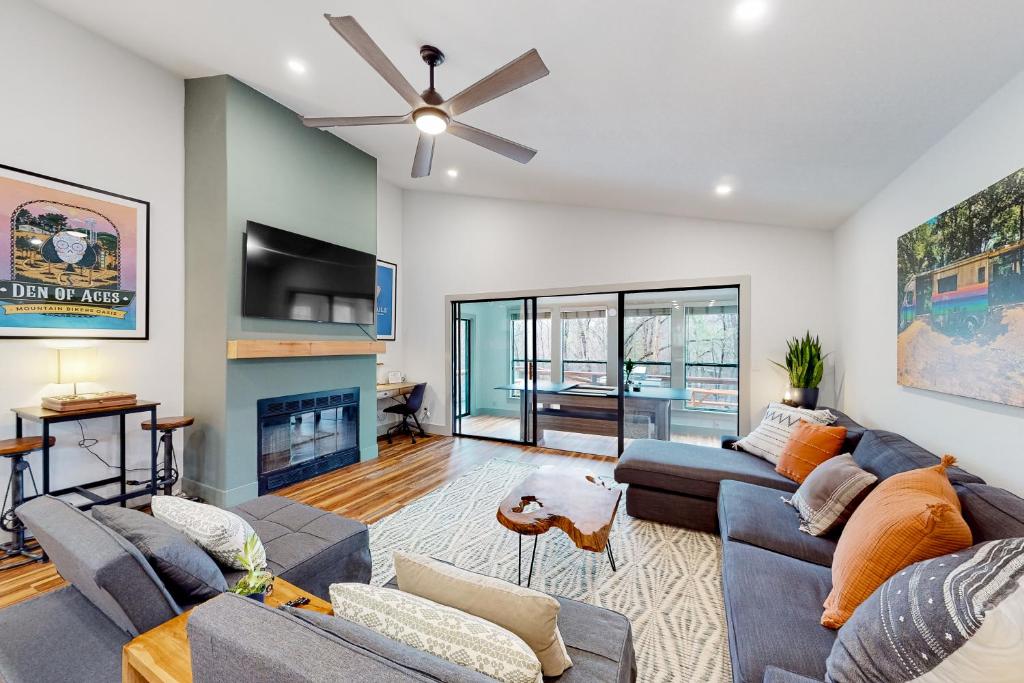 a living room with two couches and a fireplace at Donington Delight in Bella Vista