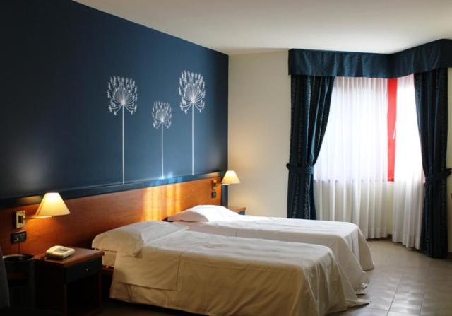 Postel nebo postele na pokoji v ubytování DOMUS Grand Hotel