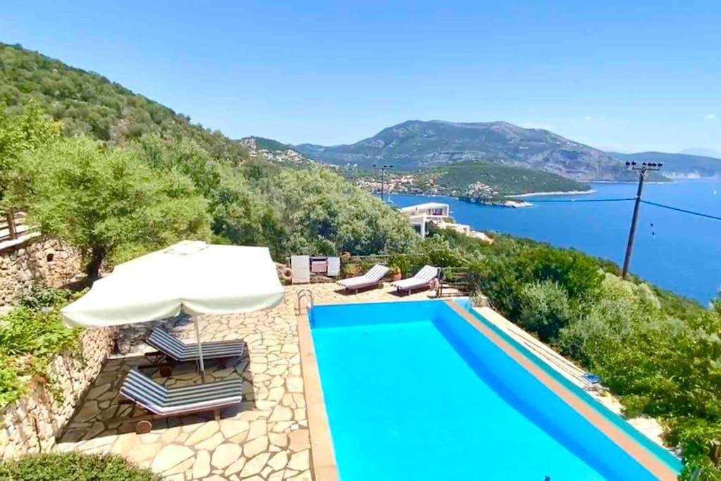 a swimming pool with a view of the water at The Lookout, boutique villa. in Sivota
