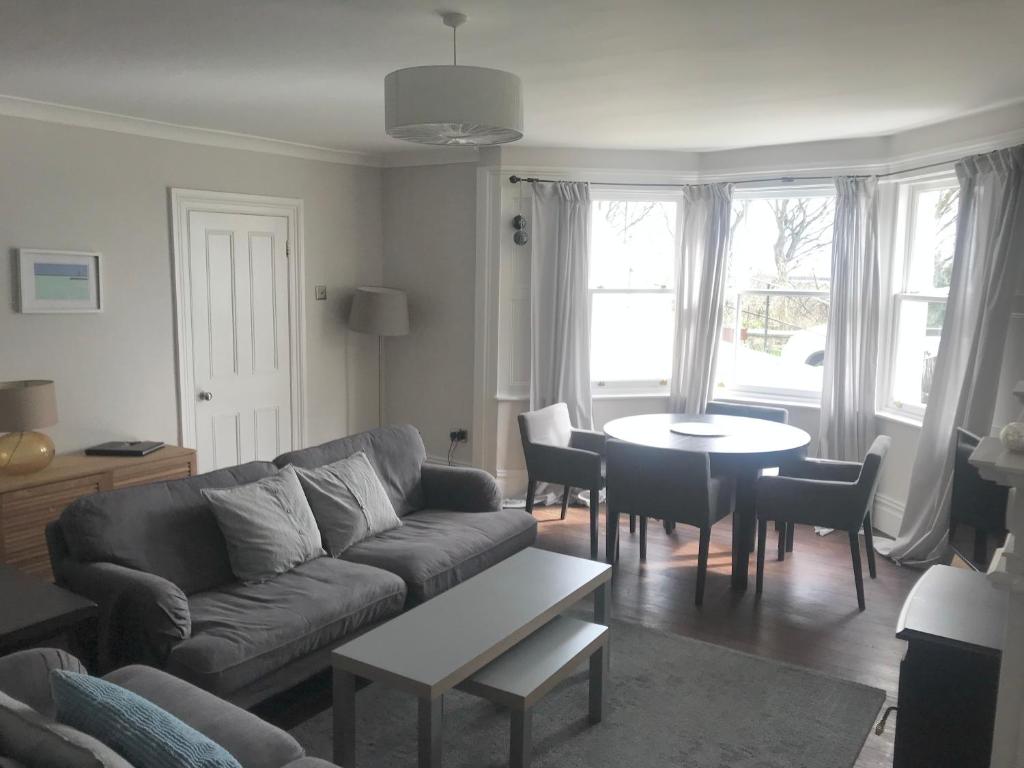 een woonkamer met een bank en een tafel bij Collingwood House Tynemouth in Tynemouth