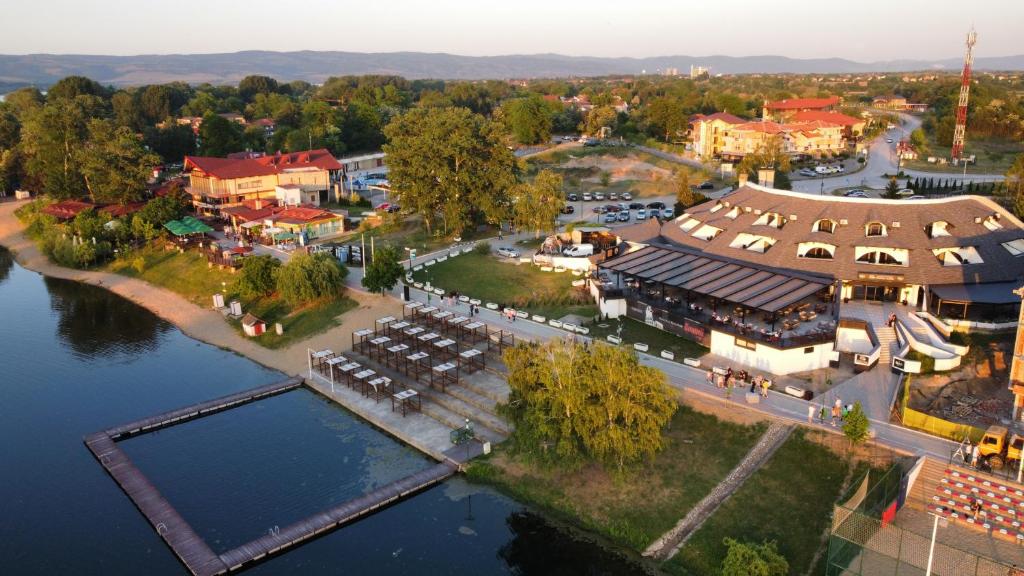 an aerial view of a town with a river and buildings at Prenoćište Srebrno Jezero in Veliko Gradište