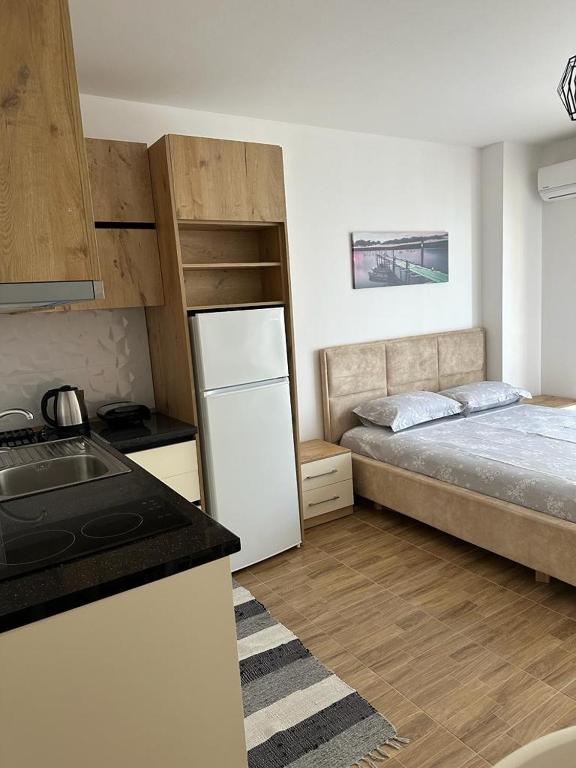 a kitchen with a refrigerator and a bed in a room at Sea View Mario's Studio in Sakës