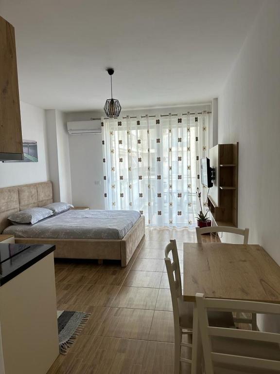 a living room with a bed and a table at Sea View Mario's Studio in Sakës
