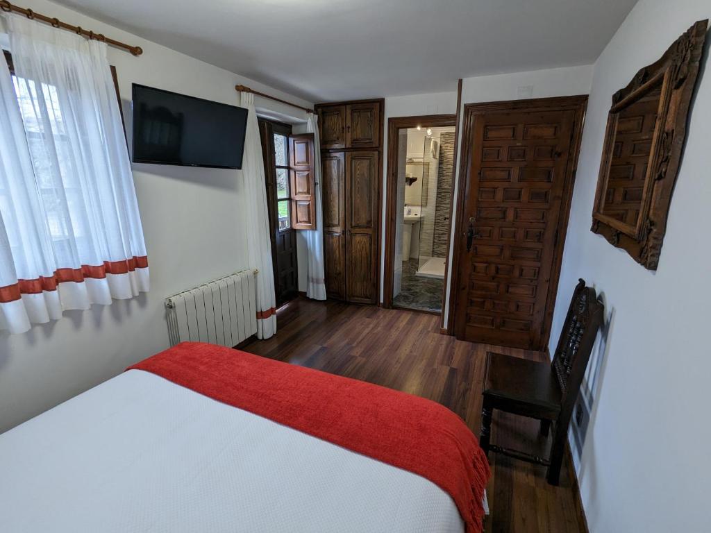 A bed or beds in a room at Posada Revolgo