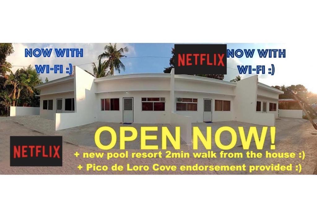 a advertisement for a new pool resort km walk from the house at 2BR townhouses good for 12pax each & NETFLIX & 100Mbps WIFI & pool resort 2min walk & 3km outside Pico de Loro Cove & Calayo Cove - with Endorsement for Pico de Loro Cove daytour & Boat-Tour & Island Hopping assistance in Nasugbu