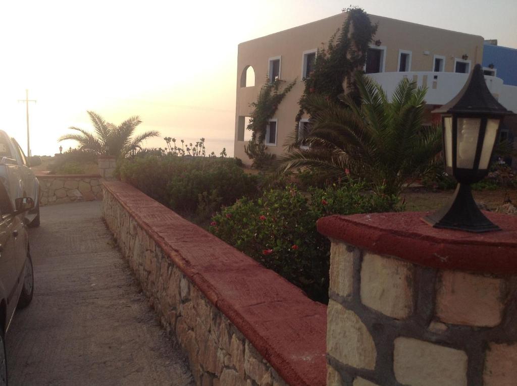 a street light next to a wall next to a building at Archipelagos Apartments in Arkasa