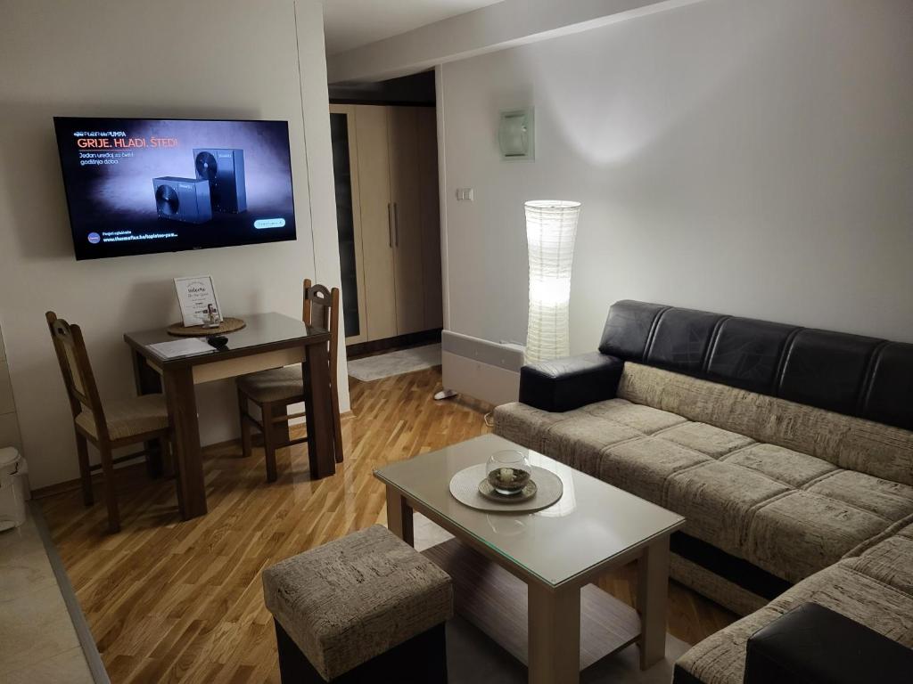 a living room with a couch and a table at OPTIMUM 2 - One bedroom apartment in Zenica