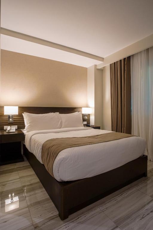 Postel nebo postele na pokoji v ubytování Hotel Areca