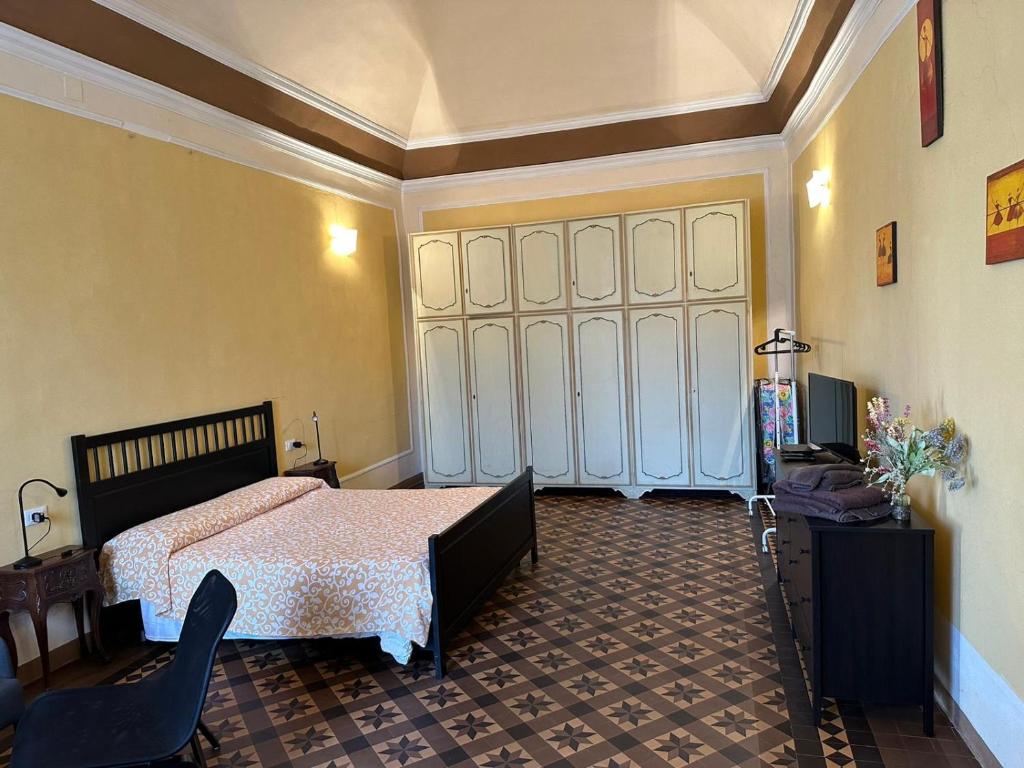 a bedroom with a bed and a large door at Casa Cavour in Pontremoli
