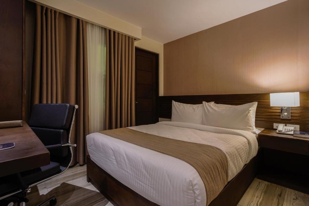 Postel nebo postele na pokoji v ubytování Hotel Areca