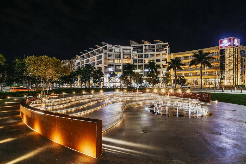 a large fountain in front of a building at night at 12 Palm Boulevard in Durban