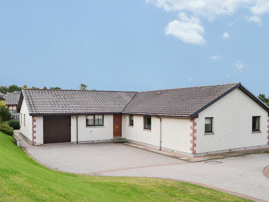 a large white house with a large driveway at Sandy Beach in Nairn