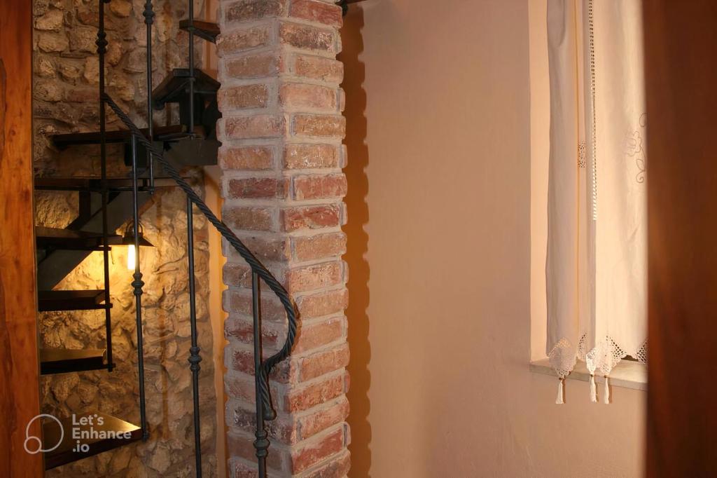 a room with a brick wall and a fire hydrant at B&B Casa Sguitti nel Centro Storico tra Tropea e Capo Vaticano in Santa Domenica
