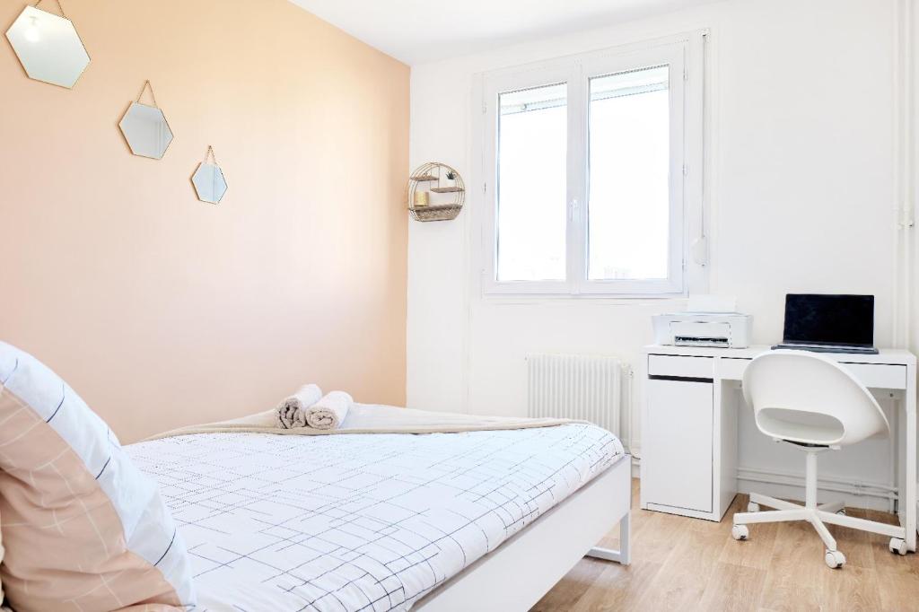 a white bedroom with a bed and a desk at Appartement Prestige - Amiens in Amiens