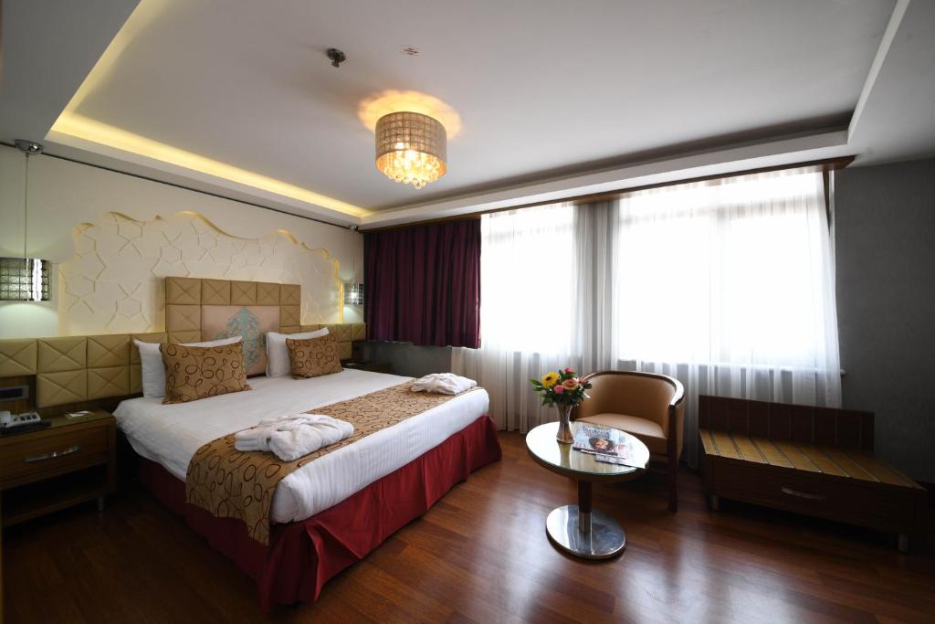 A bed or beds in a room at Grand Star Hotel Premium