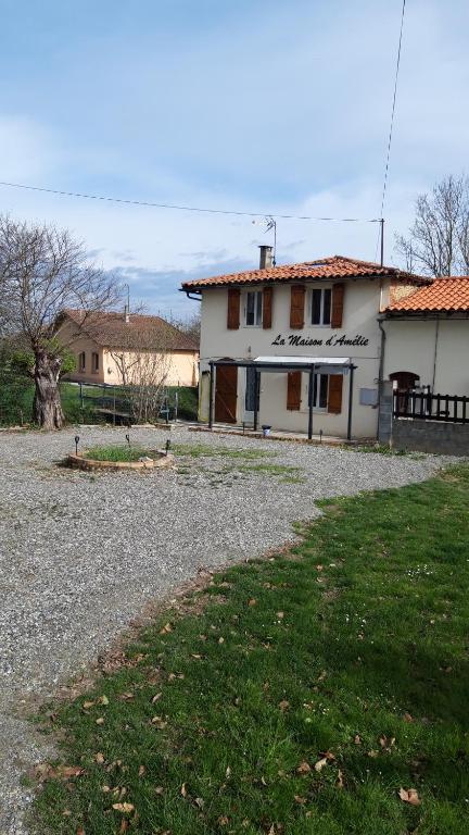 a white building with a sign on the side of it at La maison d'Amelie in Montesquieu-Volvestre