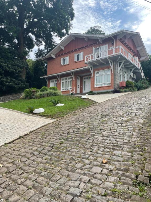 a brick road in front of a house at Casa da Nona in Gramado