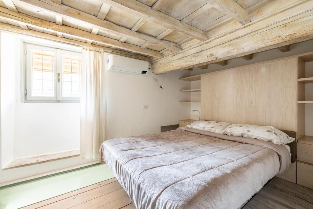 A bed or beds in a room at Ottavia al Foro - Luxury Property