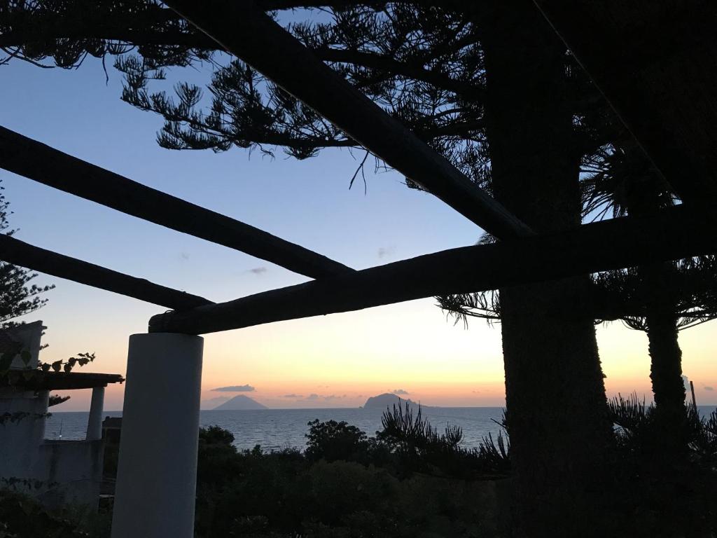 a view of the ocean at sunset from a house at Villa Lavinia in Santa Marina Salina