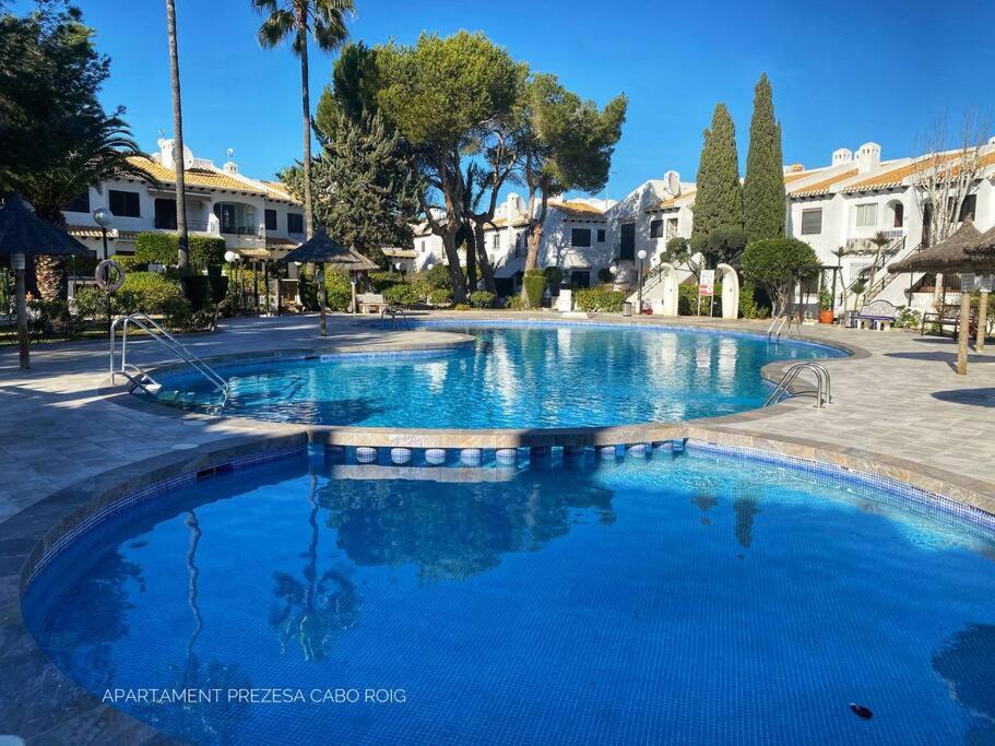 a large pool with blue water in a resort at Apartament Hola Cabo Roig in Orihuela